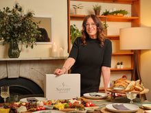Founder Anicca Stefanou with an open Savour Society box at a wooden table