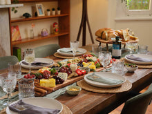 A bottle of artisan olive oil from a Savour Society drop, styled on a wooden table